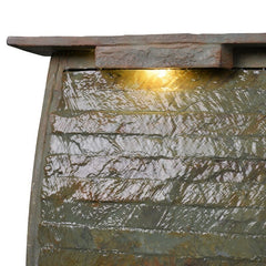 Natural Stone Floor Fountain with Light Rectangular Base Supports The water Wall, with River Stones Resting on The Bottom